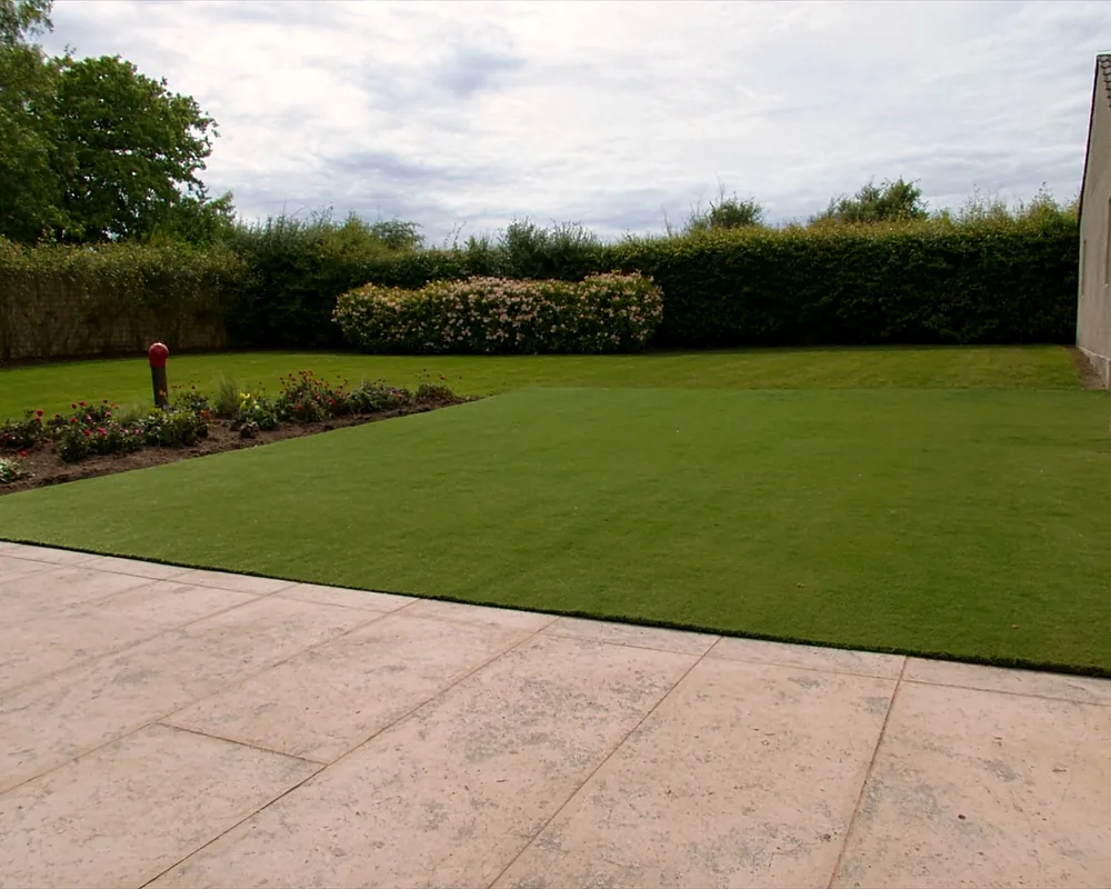 Artificial grass in a back garden beside a patio