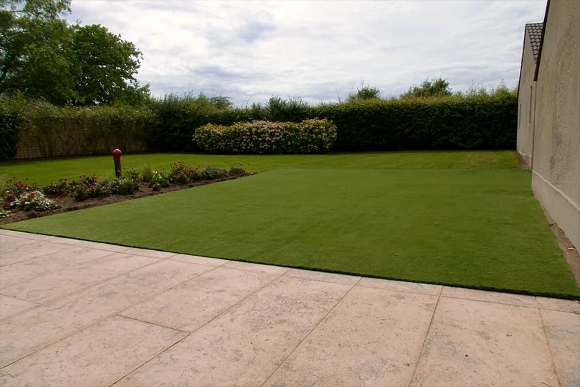Artificial grass in a back garden beside a patio