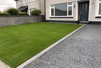 Artificial grass beside a gravel driveway