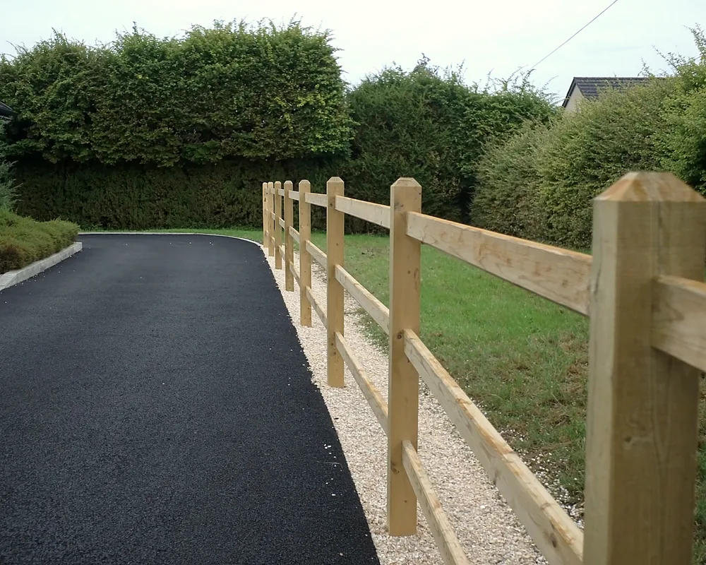 Timber post and rail fencing beside a driveway
