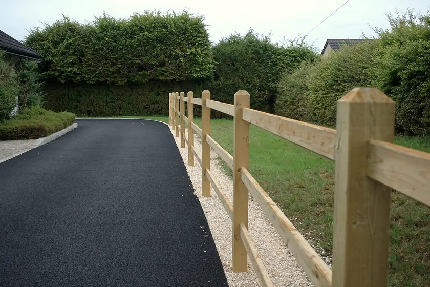 Timber post and rail fencing beside a driveway